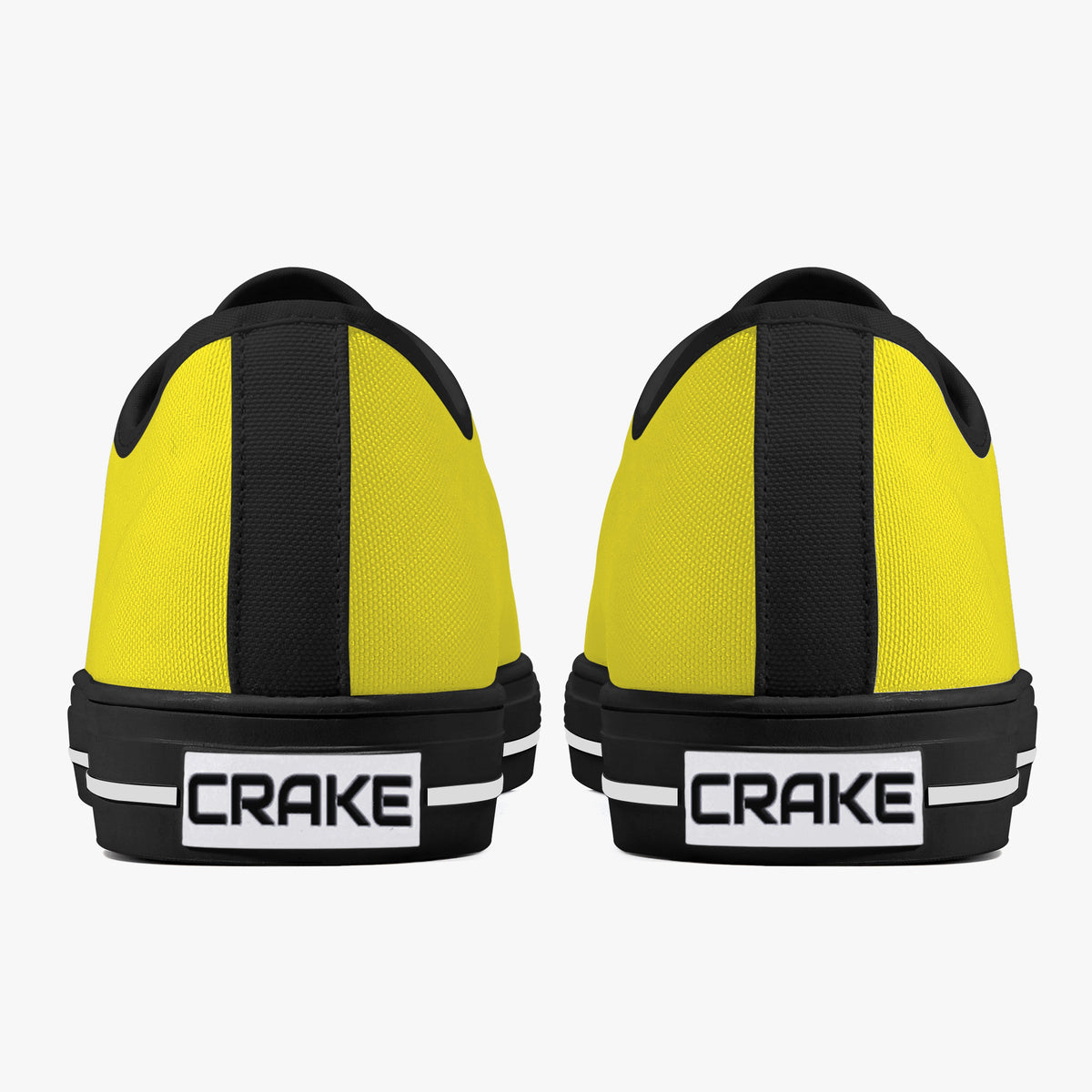 Rear view of Crake Low Top Yellow Sneaker pair with black heel stripe and Crake logo