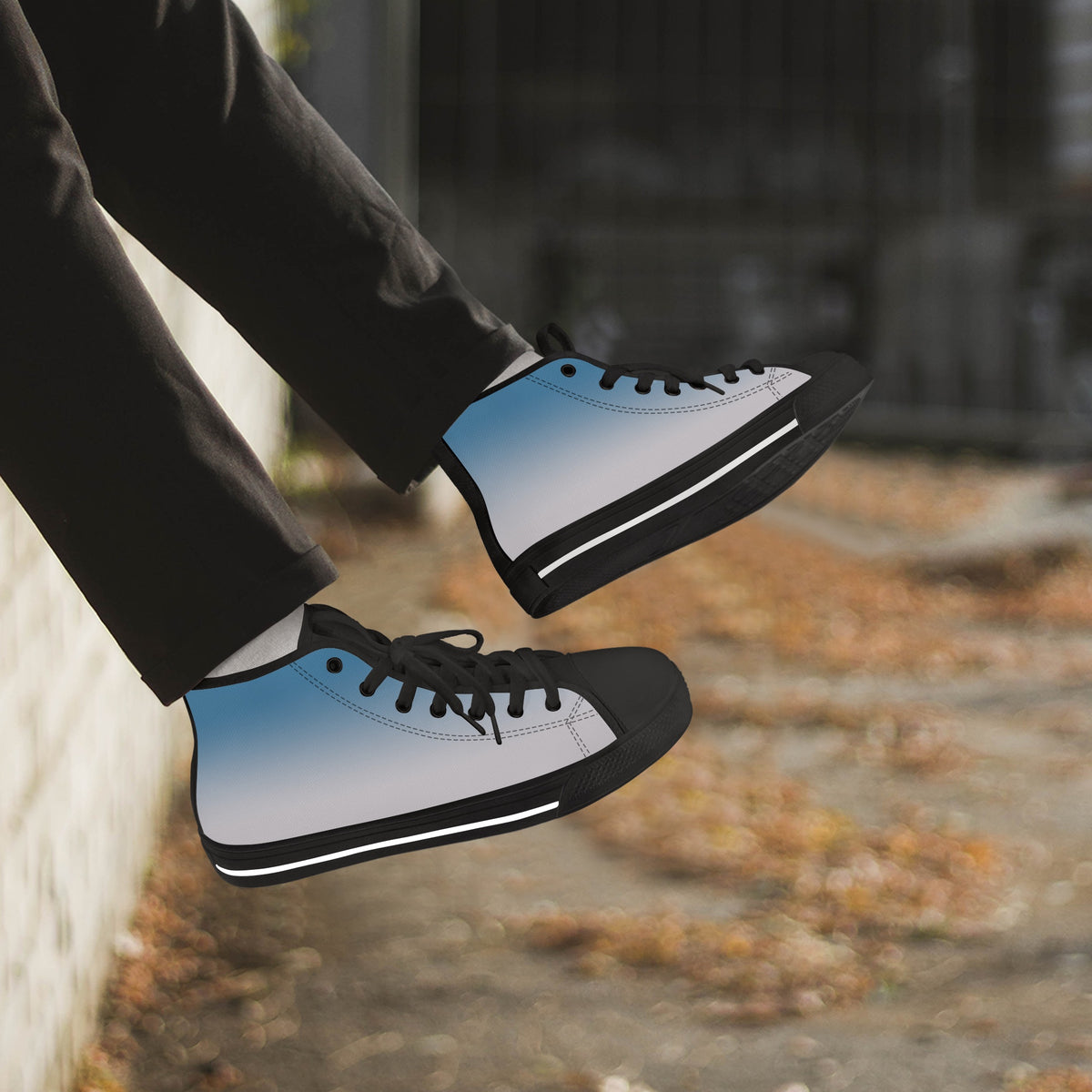 Crake High Top Sky Sneaker with black trim worn with dark trousers outdoors