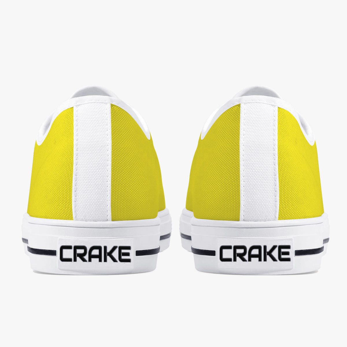 Rear view of Crake Low Top Yellow Sneaker pair with white heel stripe and Crake logo