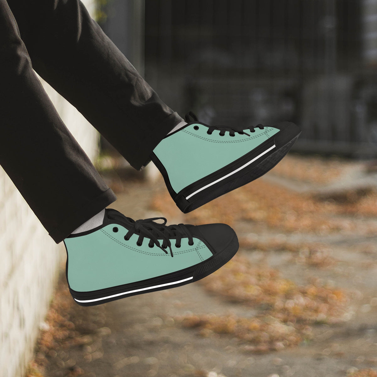 Crake High Top Mint Sneaker with black trim worn with dark trousers outdoors